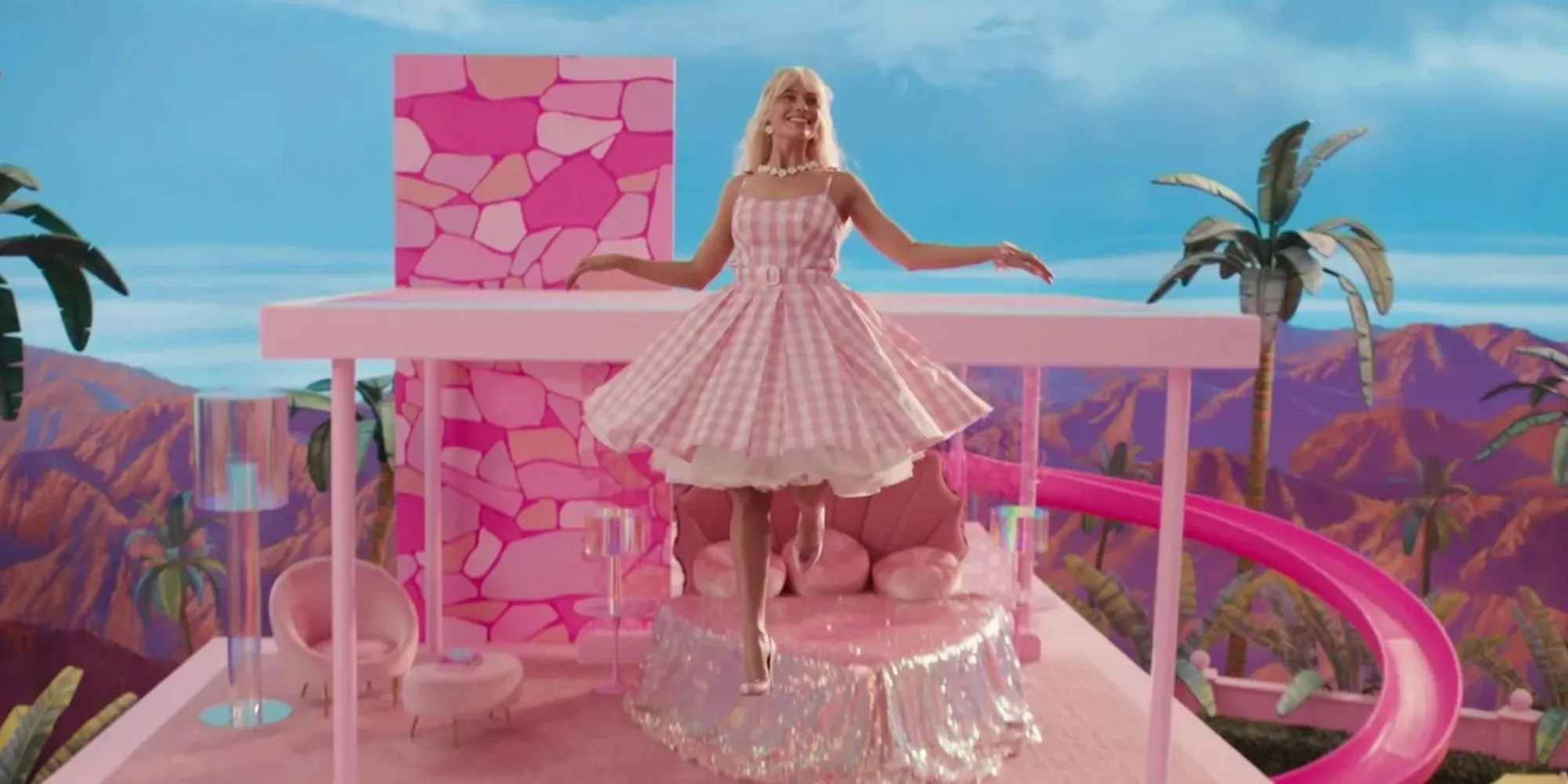 Margot Robbie trong vai Barbie nổi lên từ ngôi nhà mơ ước màu hồng, tượng trưng cho thành công vượt trội của bộ phim.